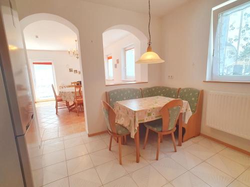 a kitchen and dining room with a table and chairs at Nr 75 Holiday house Sigrid and Alfred in Gyenesdiás