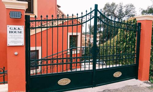 a black wrought iron gate in front of a house at GKK House private swimming pool luxury house in Skriperón