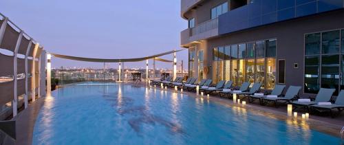 a large swimming pool on the side of a building at Damac Mall Street Residences in Dubai