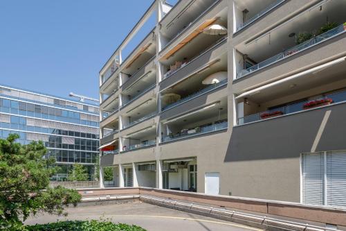 an apartment building with balconies on the side of it at City Apartment in Opfikon