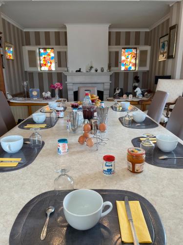 a table with plates and bowls on top of it at La Mansardière in Cancale