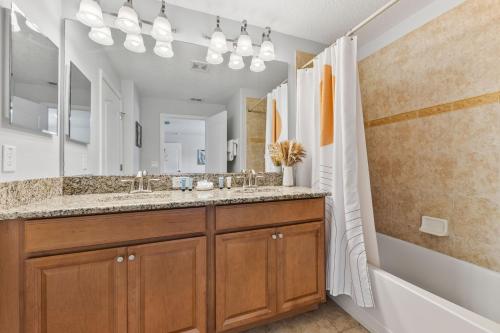 a bathroom with a double sink and a shower at 8847 Candy Palm Rd in Kissimmee