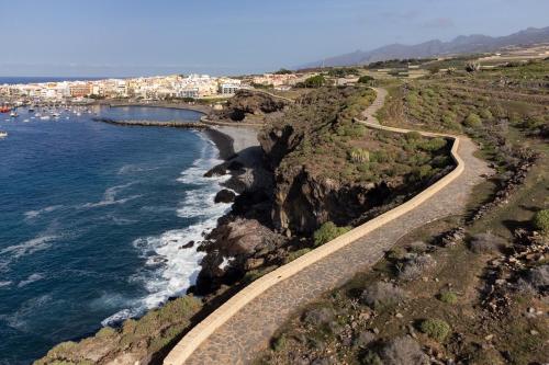an aerial view of the ocean and a rocky coast at Home2Book Panoramic Sunset Terrace Escape in Guía de Isora