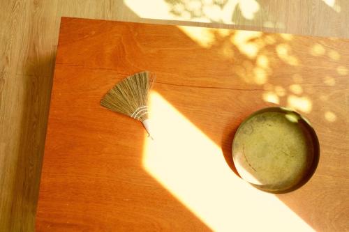 a wooden table with a spoon on top of a table at Pyoseon Mansion in Seogwipo