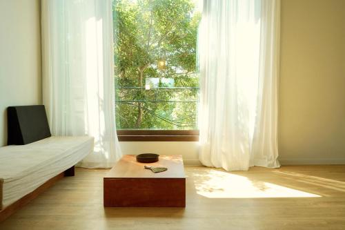 a bedroom with a bed and a large window at Pyoseon Mansion in Seogwipo