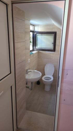 a small bathroom with a toilet and a sink at La Primavera in Palmi