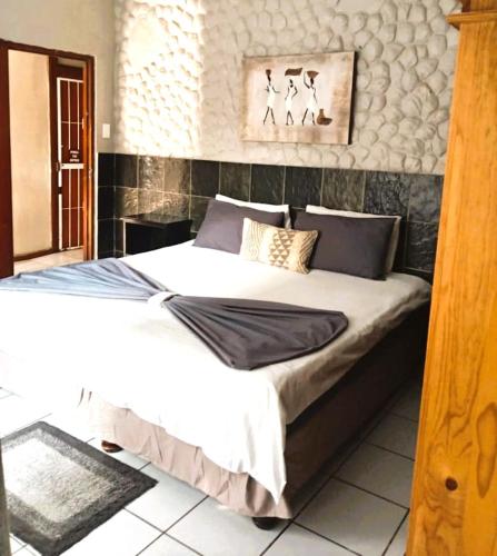 a bedroom with a large bed in a room at The Airport Lodge - East London in East London