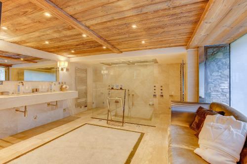 a large bathroom with a shower and a couch at Megeve Luxury Estate The Royal Alpine Retreat with Mont Blanc View in Demi-Quartier