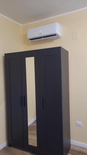 a black cabinet with a light on the ceiling at La Primavera in Palmi