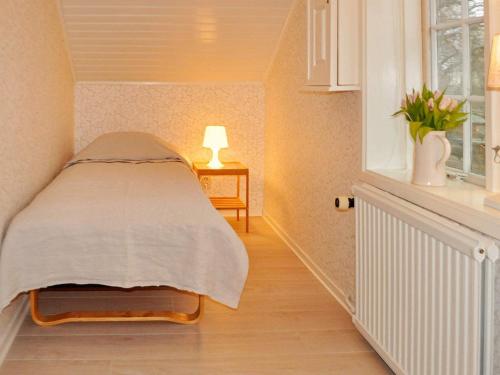 a bed in a room with a window at 8 person holiday home in Vargön in Västra Tunhem