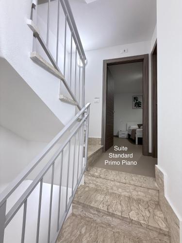 a staircase in a house with white walls at Gomes Comfort House SUITE in Valeggio sul Mincio