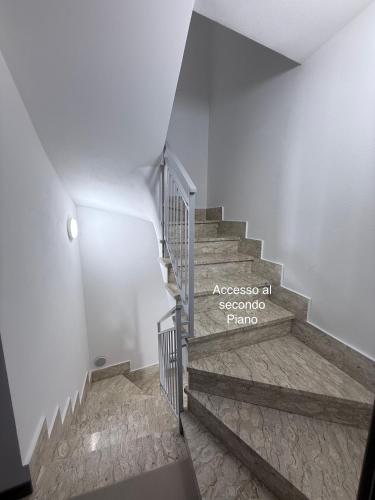 a staircase with a sign that reads access at secondoro parma at Gomes Comfort House SUITE in Valeggio sul Mincio