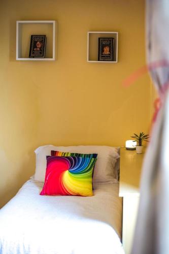 a colorful pillow sitting on a bed in a room at Suite Paradiso Umbria 15 minutes A1 Rome 1 hour in Amelia