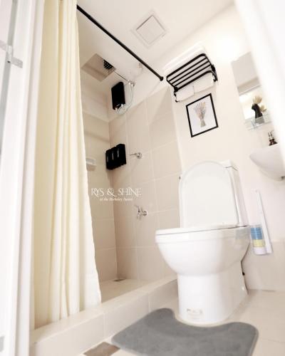 a bathroom with a toilet and a shower at RYS & Shine in Silang