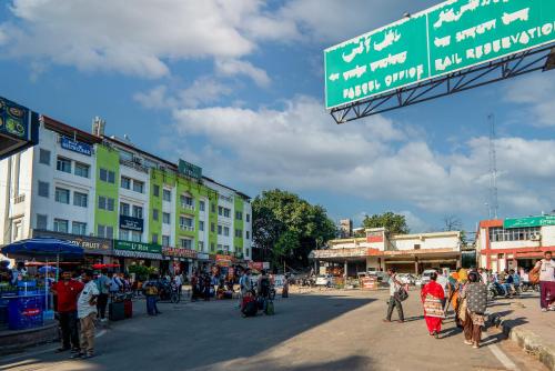 a group of people walking around a street with buildings at Le Roi Jammu - Near Jammu Railway Station in Jammu