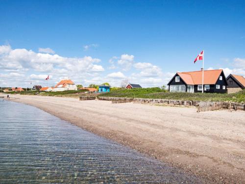 a house on the shore of a beach at 5 person holiday home in Juelsminde in Juelsminde