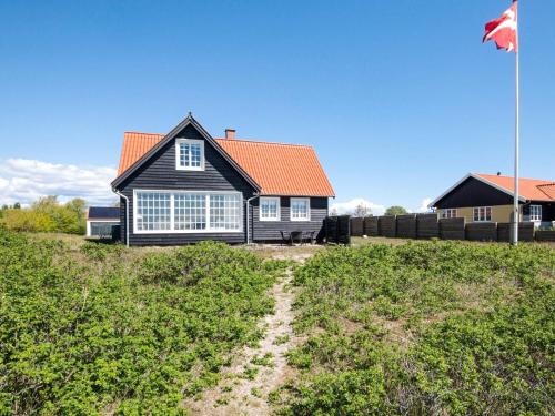 a house with a flag in front of it at 5 person holiday home in Juelsminde in Juelsminde