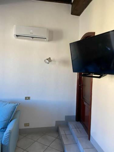 a living room with a flat screen tv on the wall at Appartamento Porticciolo in Piombino
