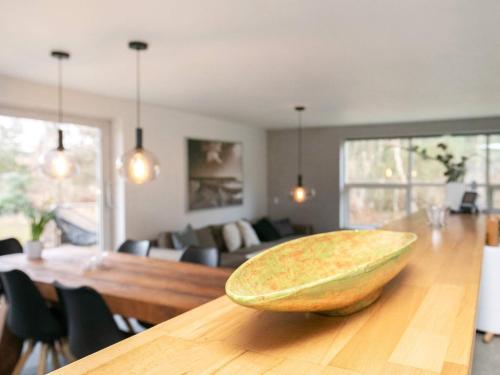 a wooden bowl sitting on a table in a living room at 6 person holiday home in Blokhus in Blokhus