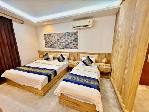 a hotel room with two beds in a room at Sheek Hotel in Erbil