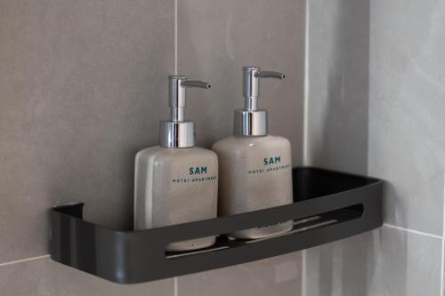 two soap bottles on a shelf in a bathroom at Sam Hotel & Apartment Da Nang in Da Nang