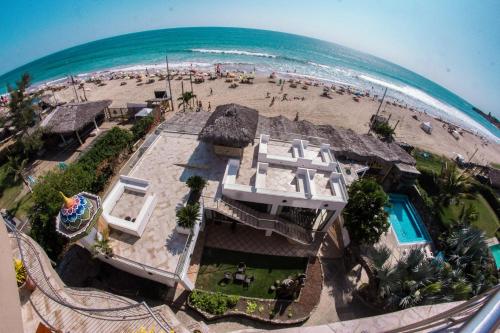 an aerial view of a house on a beach at Dharma Beach in Montañita
