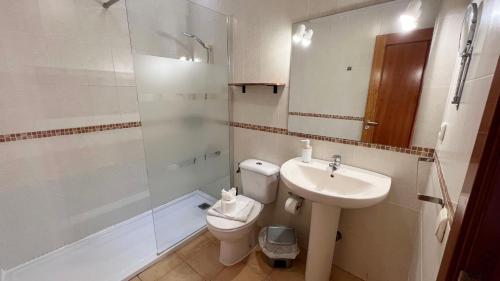 a bathroom with a toilet and a sink and a shower at Anahi Homes Corralejo- Dracaena 18 in La Oliva