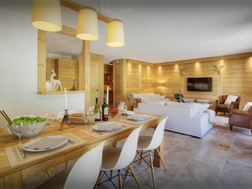 a dining room and living room with a table and chairs at Chalet Edenalpa - OVO Network in La Clusaz