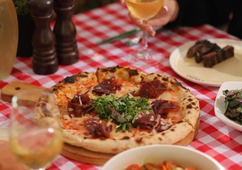 a pizza sitting on top of a table at Lancaster Eden Bay in Beirut