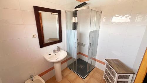a bathroom with a shower and a sink and a toilet at Anahi Homes Corralejo - Villa Drago 12 in La Oliva
