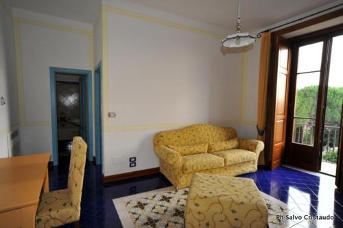 a living room with a couch and a table and chairs at Hotel Del Sole Al Plebiscito in Sapri