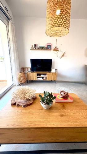 a living room with a wooden coffee table at Euphoria Luxury apartment in Faliraki