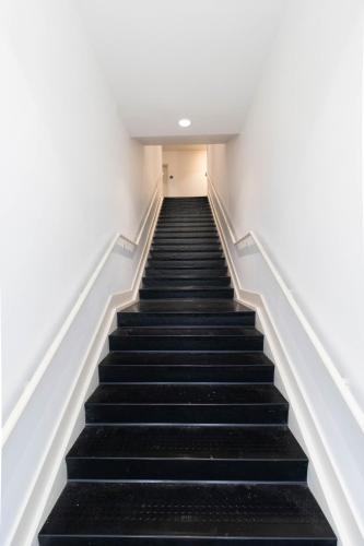 a staircase in a building with black stairs at SpringBrook Lofts in Alcoa