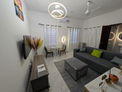 a living room with a couch and a table at Abby and Gayle Rental Apartments in Apenkwa
