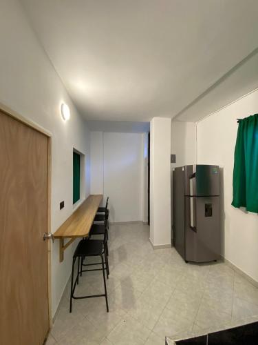 a dining room with a table and a refrigerator at Apartmento a una cuadra del aprque principal in San Rafael