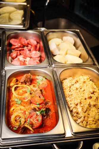 a tray of food with different types of food at Wanderlust Hostel in Maceió