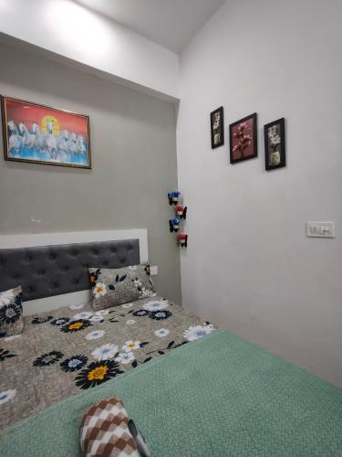 a bedroom with a bed with a green comforter at Kashu Luxury Stays in Greater Noida