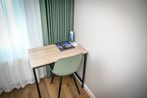 a desk with a chair and a book on it at Court Garden Hotel in The Hague
