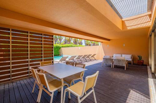 a patio with a table and chairs on a deck at Sun Salgados and Golf By Dreamplaces in Galé