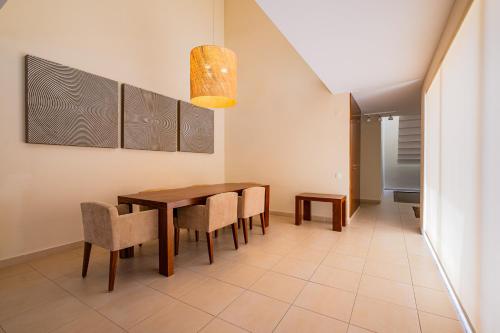 a dining room with a wooden table and chairs at Sun Salgados and Golf By Dreamplaces in Galé