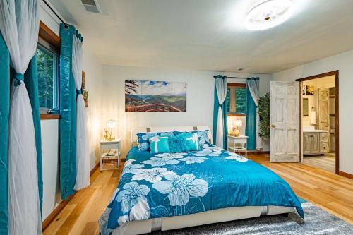 a bedroom with a blue bed and blue curtains at Horseshoe Acres - Home theater, spa room, hot tub in Oak Hill