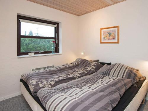 a bedroom with a bed and a window at 8 person holiday home in Sydals-By Traum in Skovbyballe