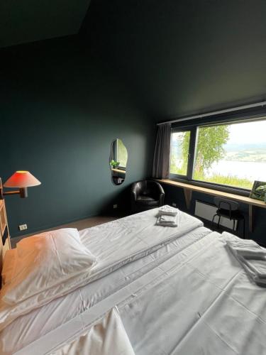 a bedroom with a large bed and a window at Fjellkysten in Tennevoll