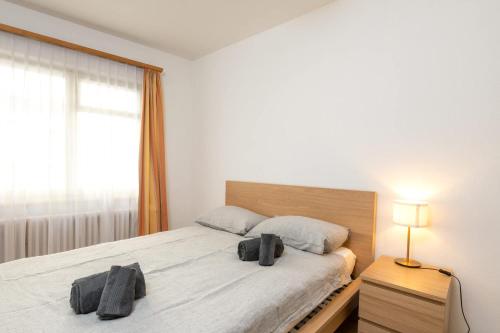 a bedroom with a bed with two towels on it at Steps from Chantarella Lift - Skies Dream in St. Moritz