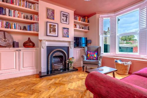 a living room with a fireplace and bookshelves at Family & Pet-Friendly Bristol Home, Near Park in Bristol
