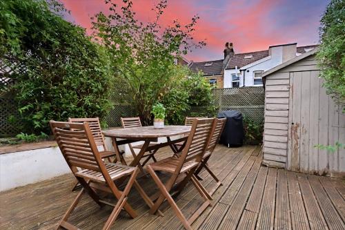 a wooden table and chairs on a wooden deck at Family & Pet-Friendly Bristol Home, Near Park in Bristol