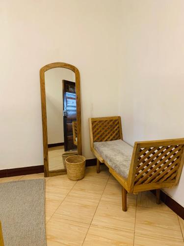 a dressing room with a chair and a mirror at Mkoani Homestay in Moshi