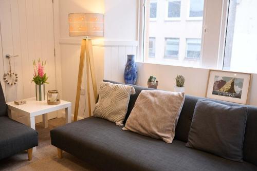 a living room with a couch and a table at Elegant 3BD Escape - Perfect Central Location in Oban