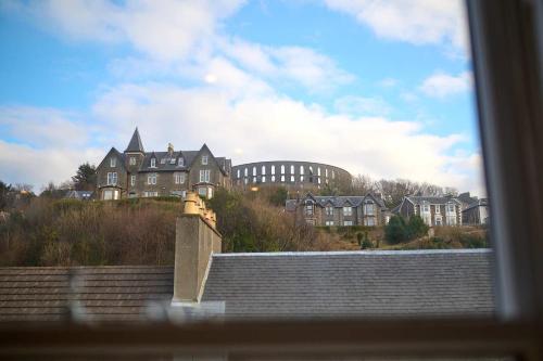 a view of a building from a window at Luxury 3BD Central Apt with Tower & Seaviews in Oban