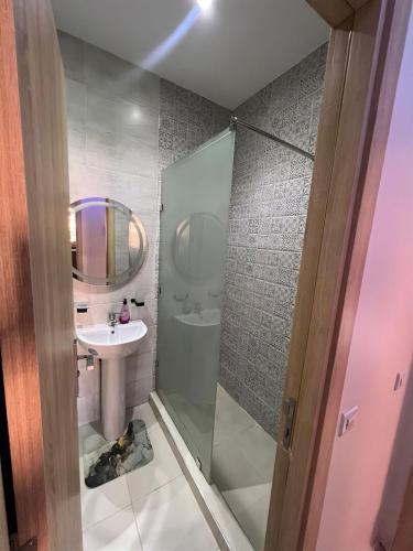 a bathroom with a shower and a sink and a mirror at sale in Oulad Akkou